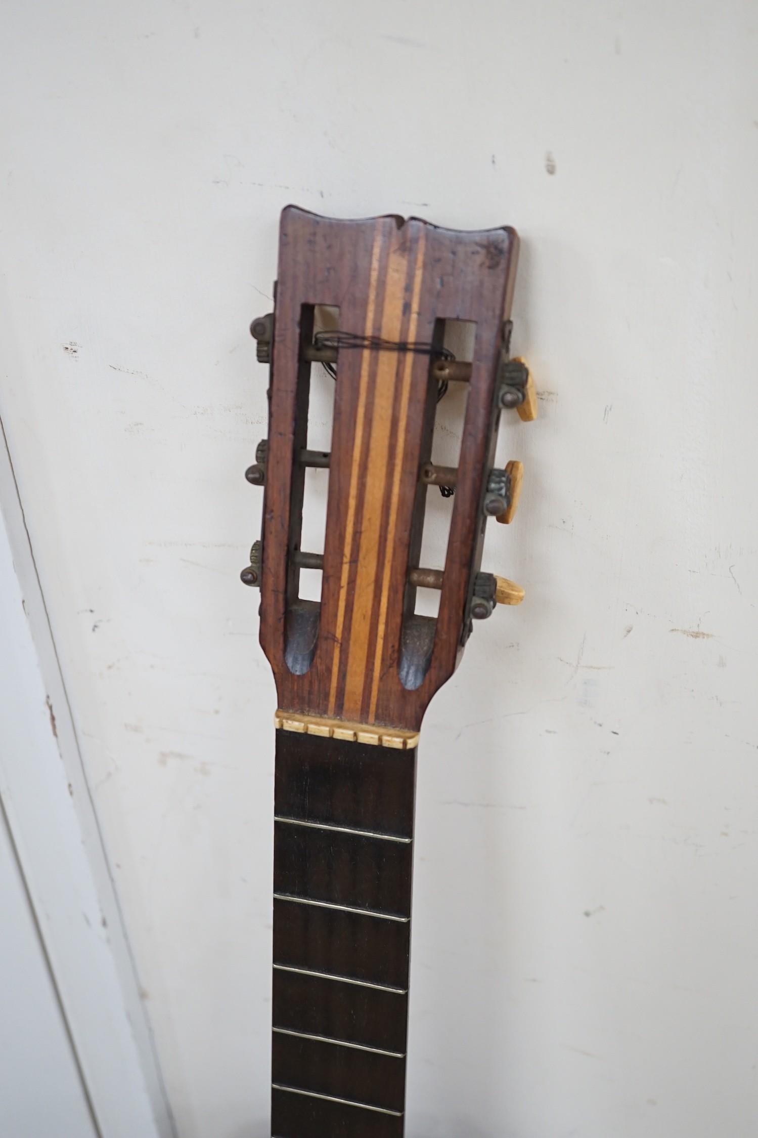 A 19th century Spanish parlour guitar labelled Antonio Carlos Garcia, Madrid. The back 46.5cm excluding button. Lacking strings, with soft case